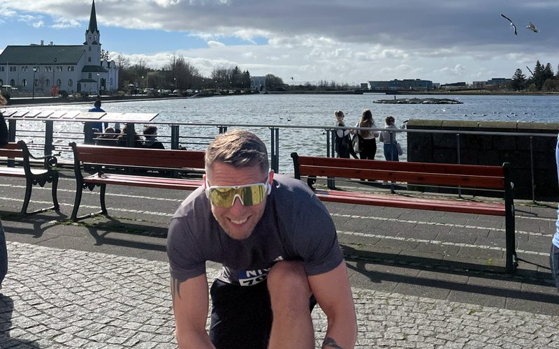 Siggi lacing up his running shoes by Tjörnin lake in central Reykjavík