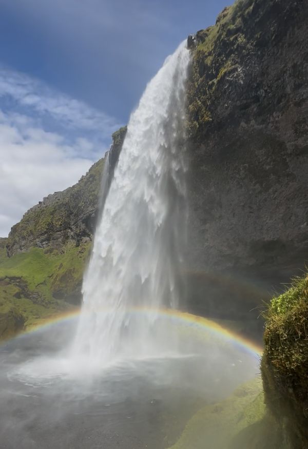 Seljalandsfoss waterfall with a rainbow in its spray