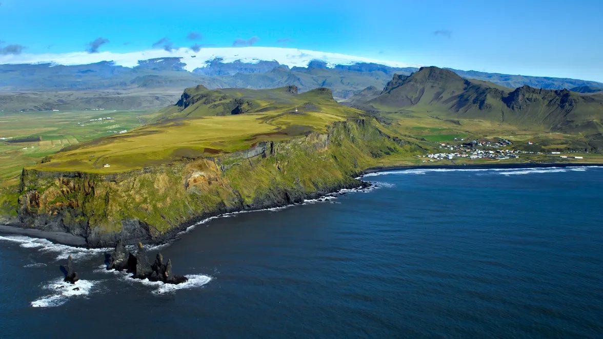 Sea cliffs and the Reynisdrangar sea stacks near Vík on Iceland’s south coast